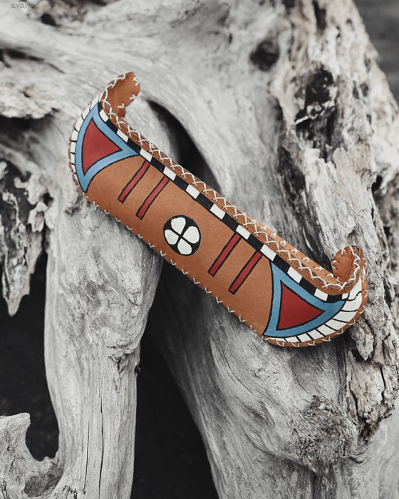Symbolic boat-shaped leather bag for sacred practices, handcrafted and hand-painted with care and intention.
