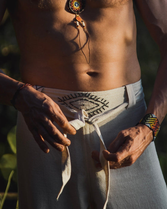 Detail of unisex boho organic cotton pants featuring a distinctive sacred geometry pattern on the belt, handcrafted for a blend of style and comfort in bohemian fashion.