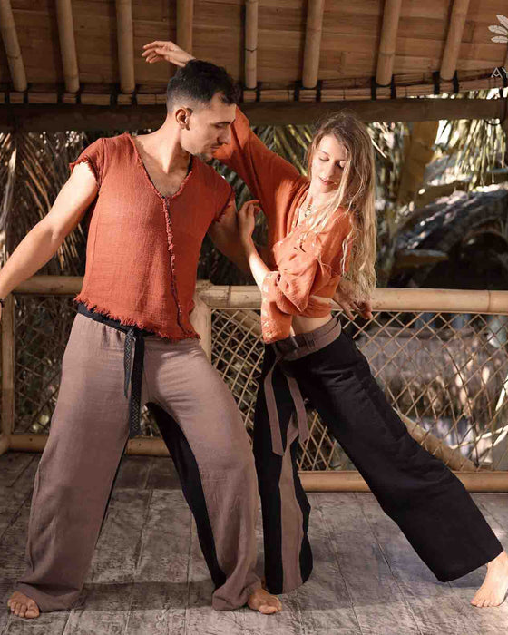 Close-up of unisex cotton pants featuring a white hand-embroidered tribal pattern, embodying Boho and shamanic styles