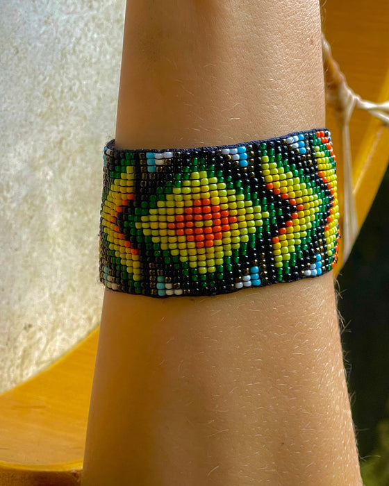 Handwoven bead loom bracelets with Ayahuasca-inspired tribal patterns, combining shamanic tools and talisman amulets for spiritual adornment