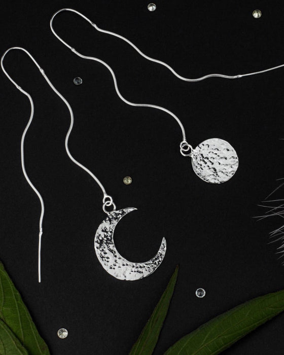 Charming mismatched silver earrings depicting the sun and moon, crafted as aesthetic shamanic tools and serving as a unique talisman for celestial harmony.