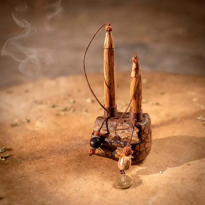 Decorative incense holder with sticks on a textured surface