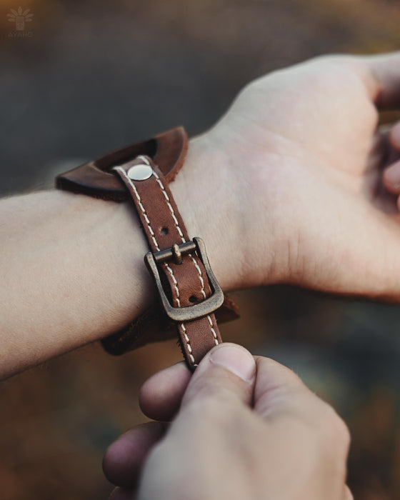Handmade leather cuff with a triple-infinity pattern, designed for strength, energy, and meaningful style.
