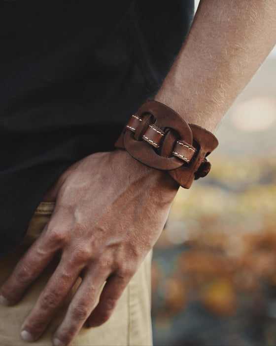 Handcrafted men’s leather cuff with triple-infinity design, symbolizing everlasting flow and cyclical energy.