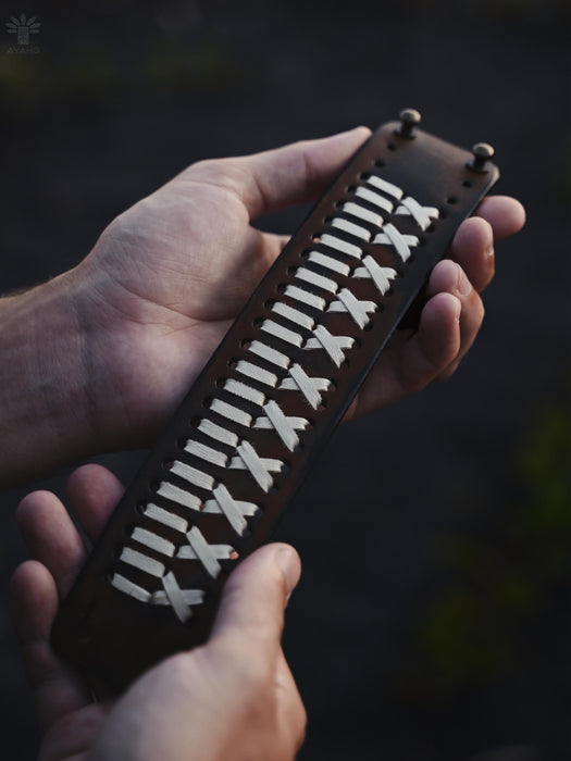 Bold, handcrafted buffalo leather bracelet, symbolizing raw energy and deep ancestral roots for the modern man.