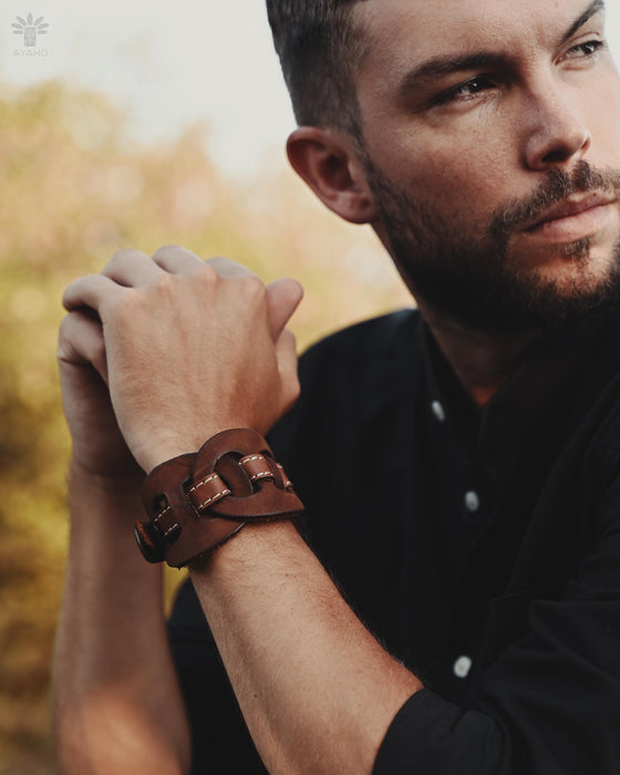 Durable buffalo leather cuff featuring triple-infinity symbols, made in Bali and charged with the island’s magic.