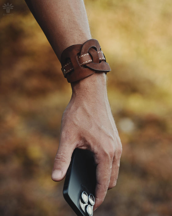 Bold and substantial buffalo leather cuff with triple-infinity design, representing timeless energy and cyclical power.