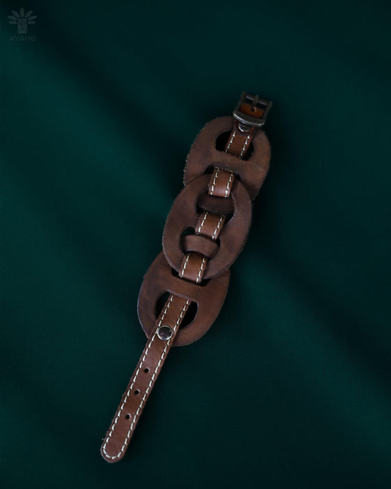 Leather cuff with triple-infinity pattern, handcrafted in Bali and designed to elevate both style and spiritual energy.