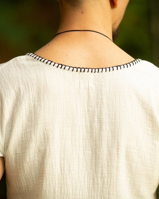 Crafted with meticulous attention to detail and a deep respect for ancient traditions, this boho-style short sleeve shirt is more than just clothing; it's a statement of identity and power