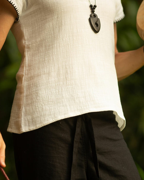Crafted with meticulous attention to detail and a deep respect for ancient traditions, this boho-style short sleeve shirt is more than just clothing; it's a statement of identity and power