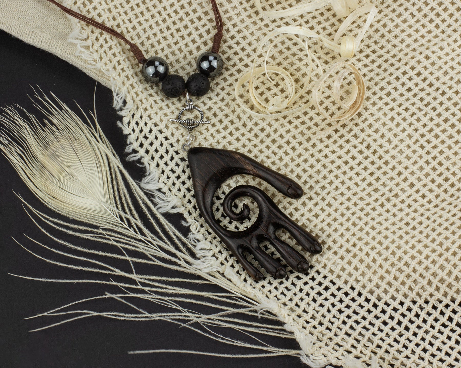 Handcrafted tribal jewelry set displayed on natural woven fabric