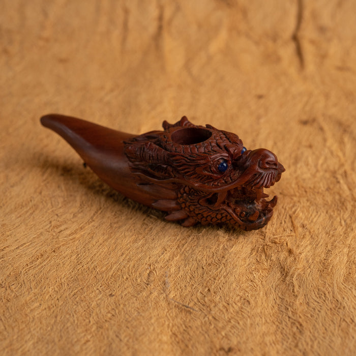 Carved wooden object on a textured brown surface