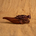 Carved wooden dragon figure on a wooden background