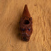 Decorative brown pipe with intricate carvings on a wooden surface