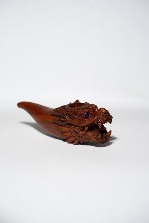 Wooden dragon-shaped object on a white background
