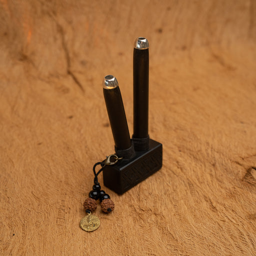 Black electronic device with a keychain on a brown surface