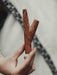 Wooden tool held by a hand with a blurred background