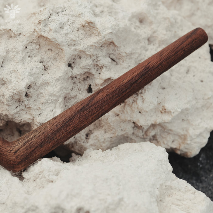 Wooden tool on a textured white surface