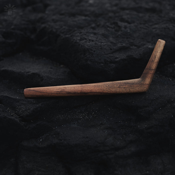 Wooden L-shaped tool on a dark textured surface