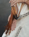 Tiny preserved owl feather in a glass vial pendant, attached to a braided leather necklace for everyday spiritual protection.