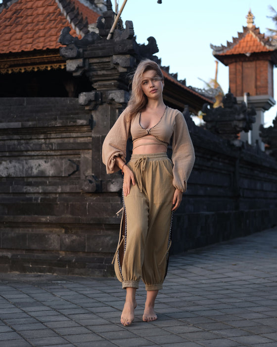 Close-up of cotton pants featuring a white hand-embroidered tribal pattern, embodying Boho and shamanic styles