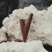 Wooden V-shaped object on a textured white surface