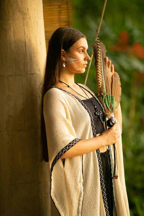 Woman holding a bow and arrow against a natural background