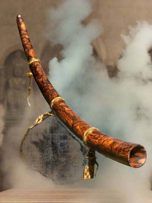 Decorative staff with gold accents on a stone surface