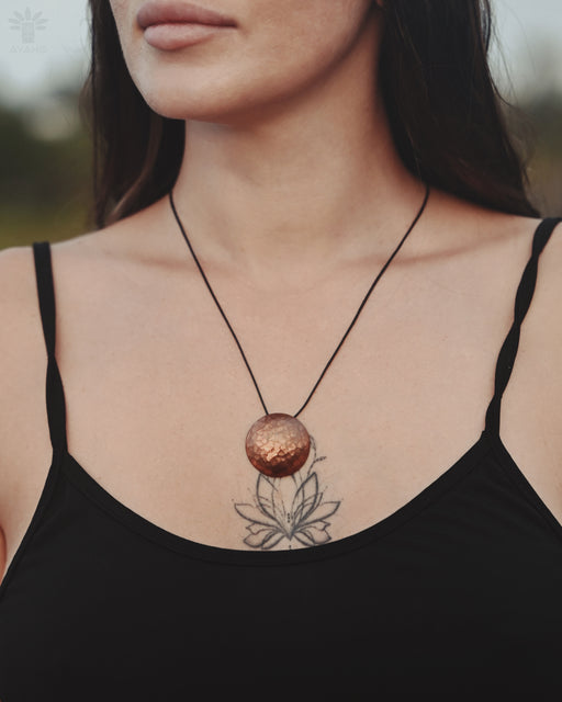 Handcrafted copper mirror designed to act as a barrier against negative energies during spiritual work.