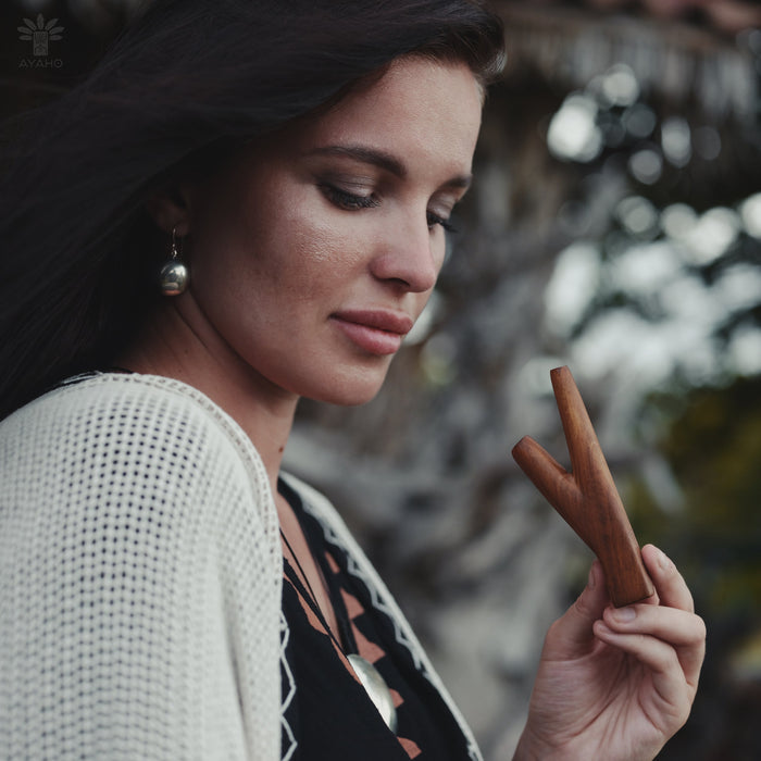 Woman holding a wooden stick with a blurred background