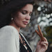Woman holding a wooden stick with a blurred background
