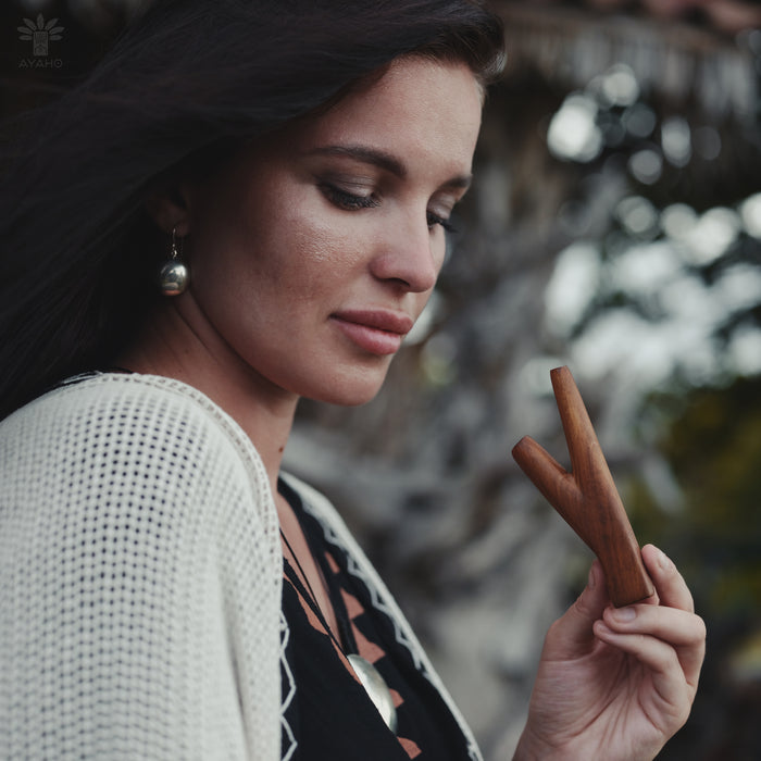 Woman holding a wooden stick with a blurred background