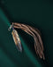 Tiny preserved owl feather in a glass vial pendant, attached to a braided leather necklace for everyday spiritual protection.