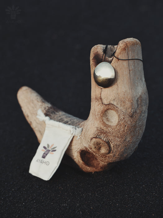 Wooden hook with a metal ball on a dark background