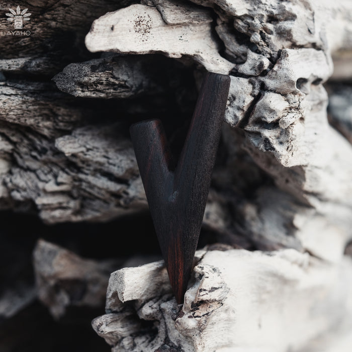 Dark metallic object embedded in a textured stone surface