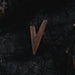 Wooden arrowhead on a dark, textured surface