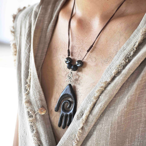 Empower your spirit with our Sacred Ebony Wood Amulet Necklace, adorned with Hematite and volcanic lava for protection and grounding. Handcrafted for beauty and spiritual reinforcement. 