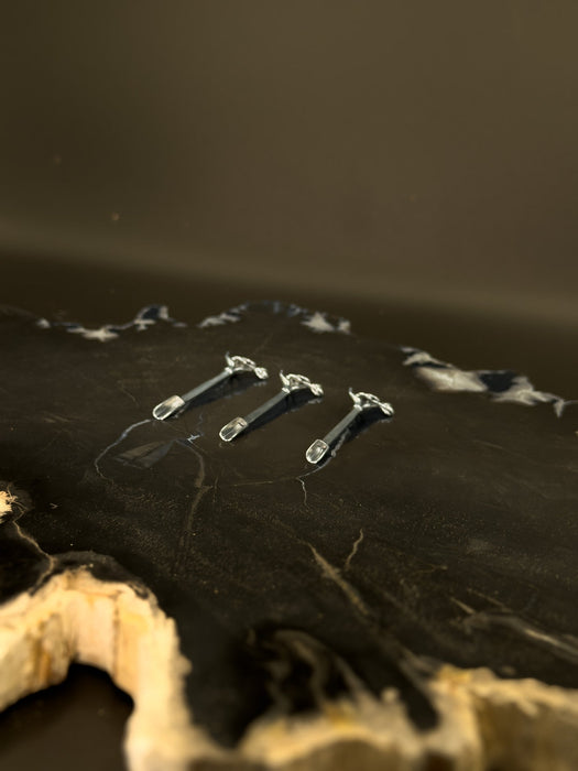 Close-up of a guitar's headstock with tuning pegs on a dark background