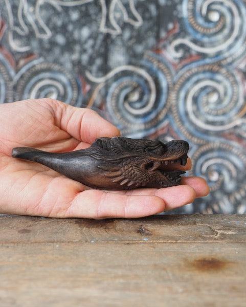 Artistic black wood smoking pipe with a stunning dragon design, a treasure for any smoking enthusiast.