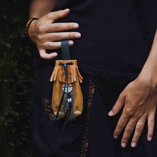 Traditionally crafted leather shamanic bag adorned with ethnic motifs, perfect for storing kuripe and hape tools, embodying the essence of ritual and tradition