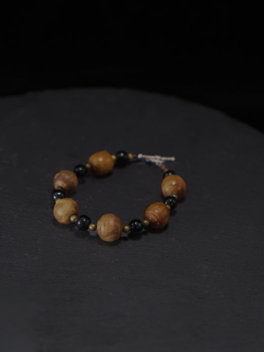 Bracelet with wooden beads on a dark background
