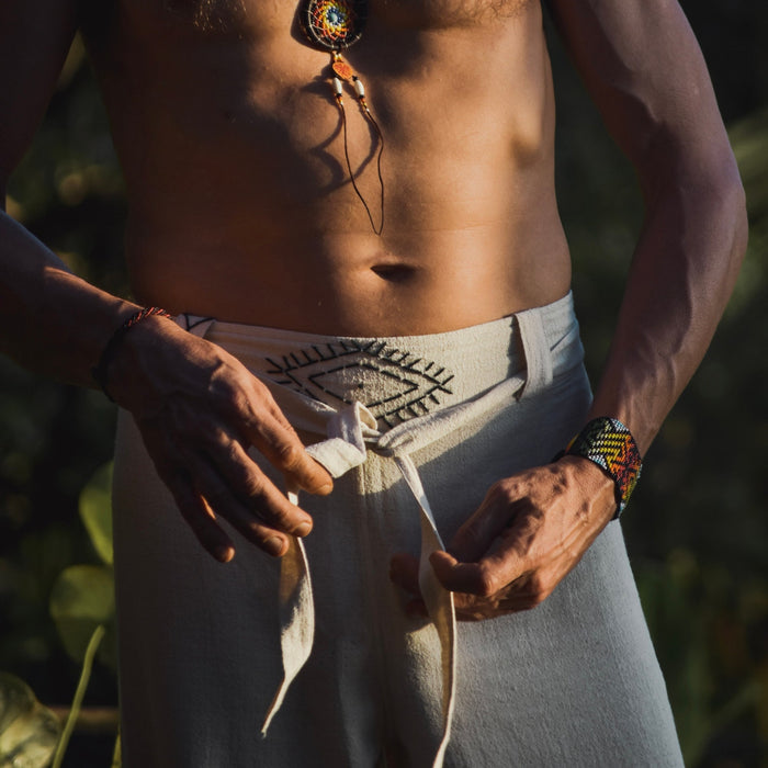 Detail of unisex boho organic cotton pants featuring a distinctive sacred geometry pattern on the belt, handcrafted for a blend of style and comfort in bohemian fashion. 
