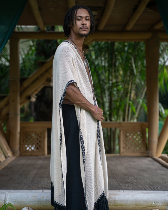 Model wearing a handmade tribal-style cotton kimono poncho with shamanic ornament, suitable for festivals and rituals