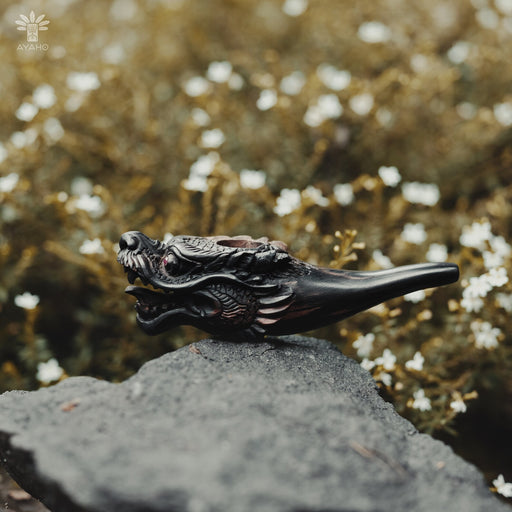 Hand carved wooden tobacco pipe, a shamanic tool for mapacho, displayed on driftwood—ideal for ceremonial use and a unique gift for smoking herbs