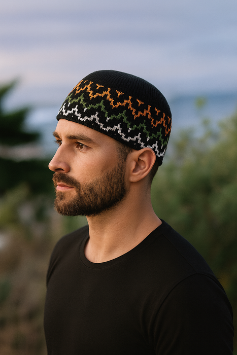 Man wearing a black knit hat with colorful patterns outdoors