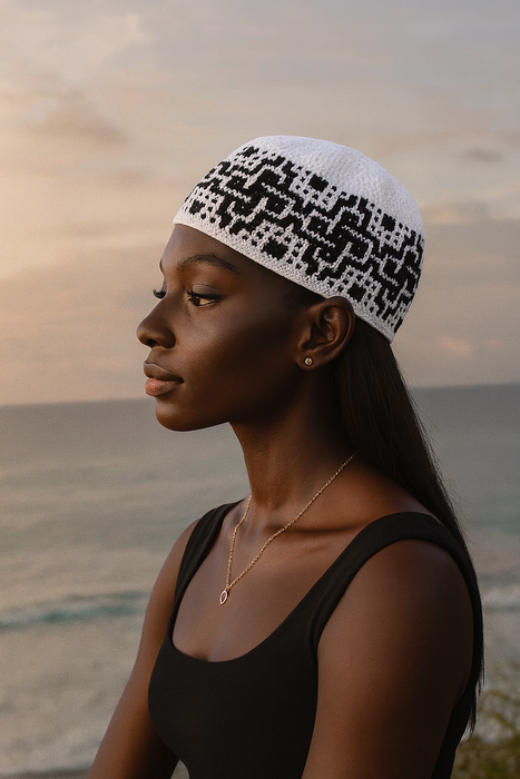 Woman wearing a black and white patterned headscarf against a sunset sky.