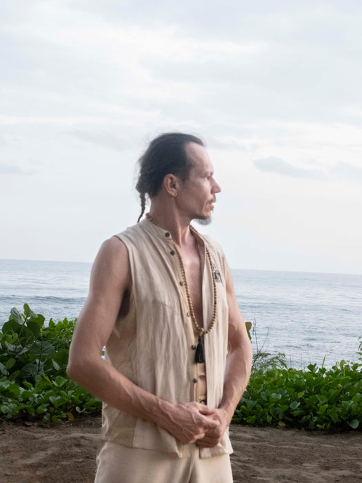 Man standing on a beach with ocean and sky in the background