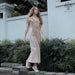 A woman gracefully descends steps in a handmade boho maxi dress with fringe detailing, perfect for bohemian festivals or a boho wedding, embodying a romantic and ethereal goddess vibe