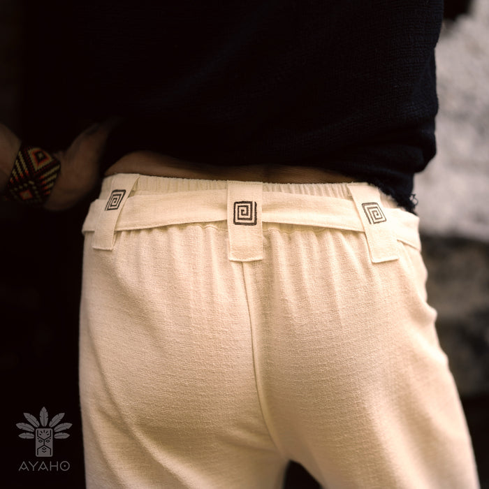 Beige pants with a brand logo on a blurred background