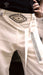 White pants with black embroidery and Ayaho branding.